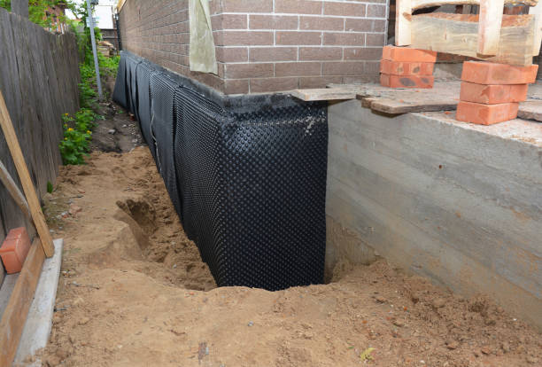 Happy homeowners after waterproofing job in Utica